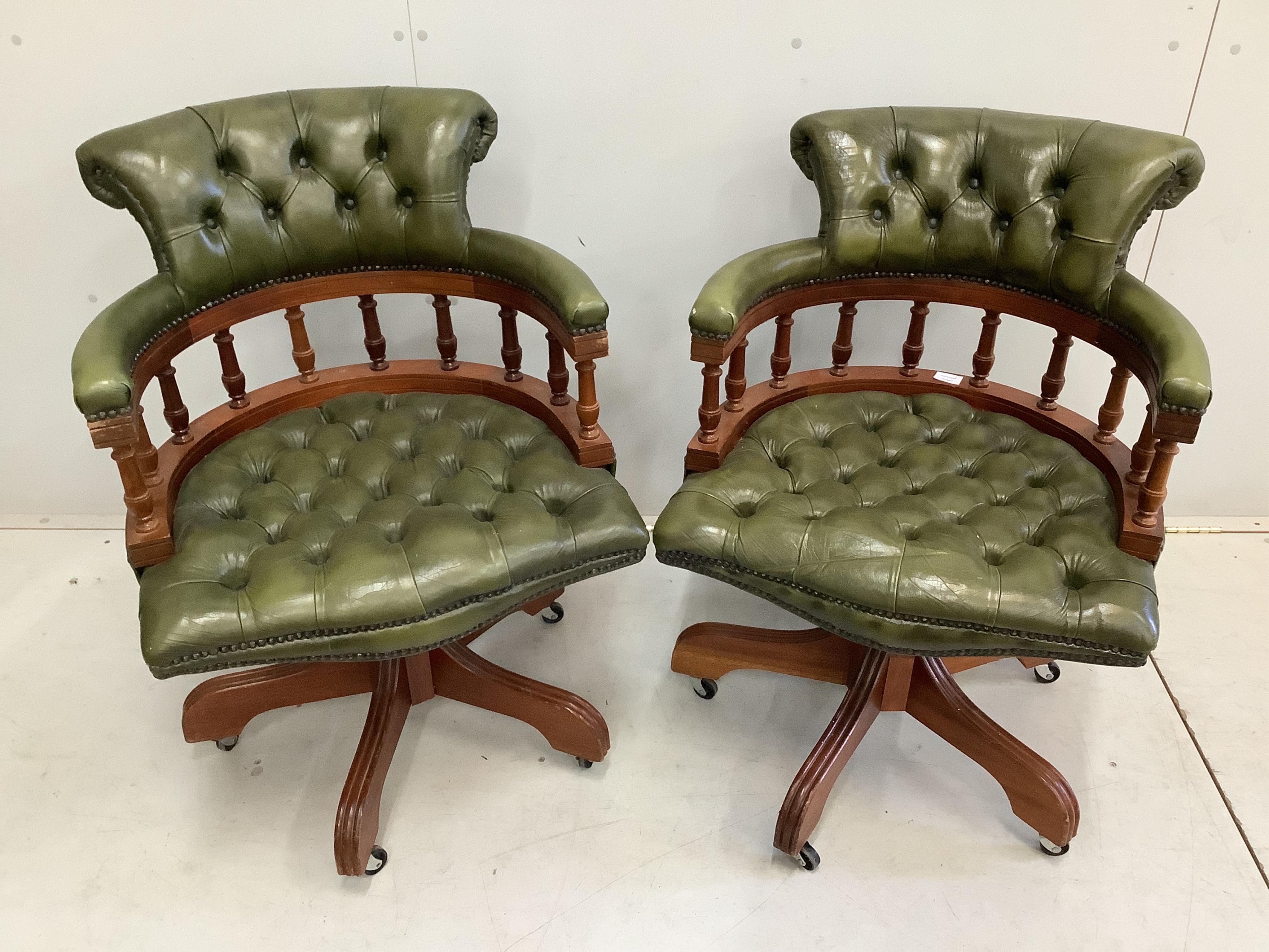 A pair of reproduction Victorian style buttoned green swivel desk chairs, width 61cm, depth 55cm, height 84cm